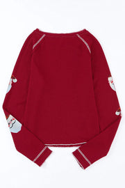 Scarlet waffle knit top with sequin Santa details on sleeves.