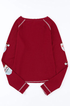 Scarlet waffle knit top with sequin Santa details on sleeves.