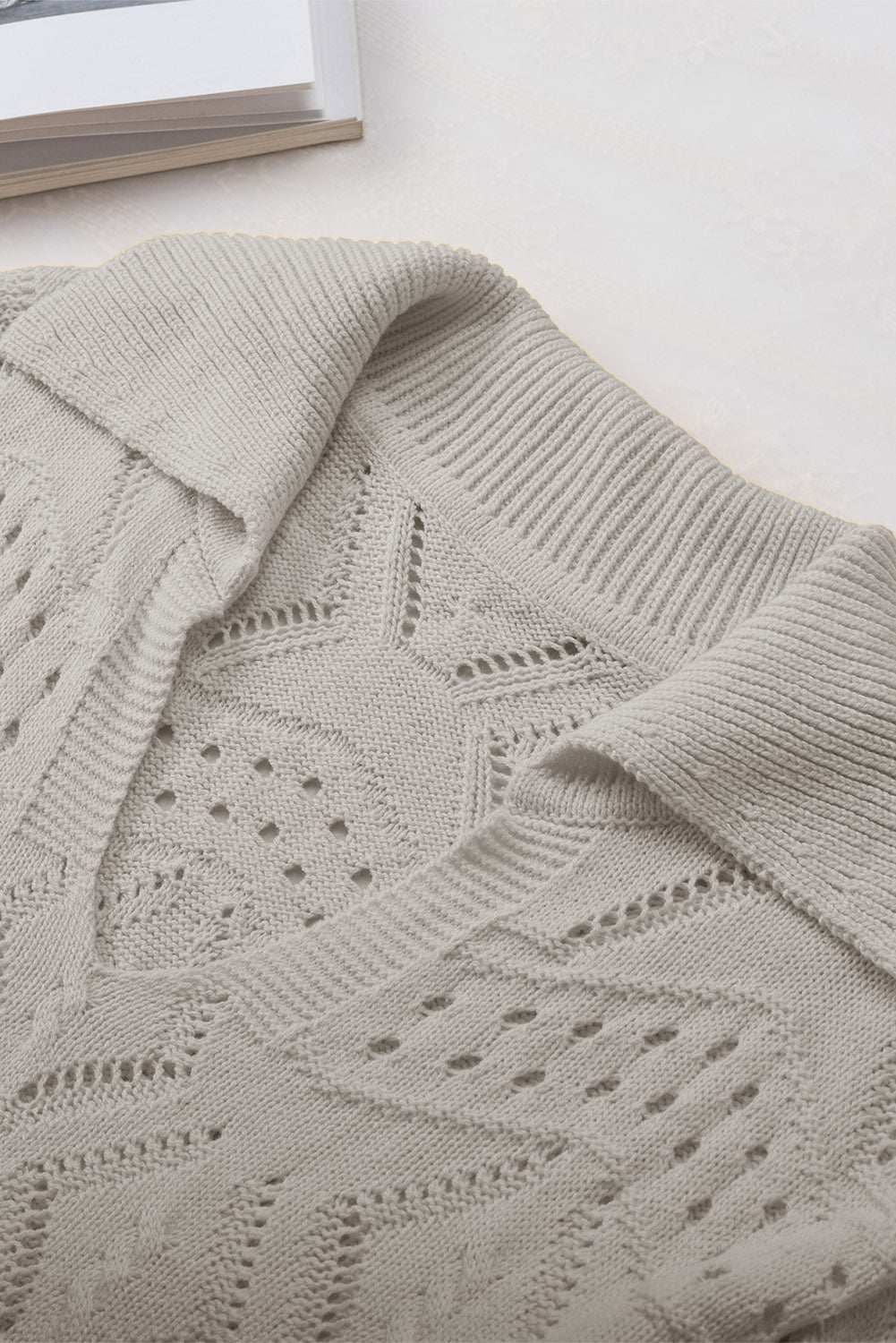 Gray openwork collar knit sweater with intricate stitch patterns and a relaxed fit.