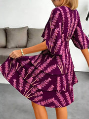 Purple floral tiered ruffle hem dress with flutter sleeves.