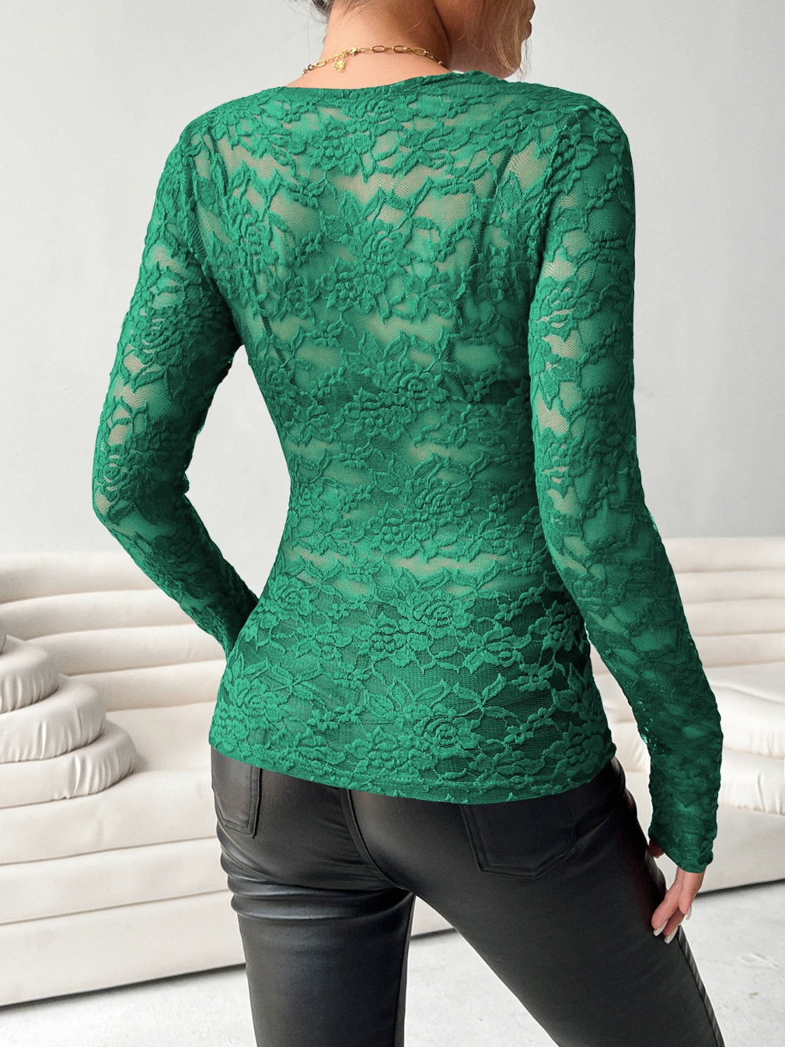 Dark green lace long sleeve second-skin top with floral pattern.