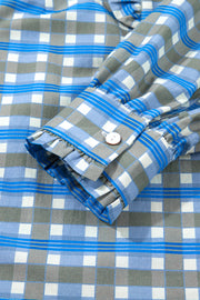 Blue plaid button-down blouse with frilled cuff detail and white button.