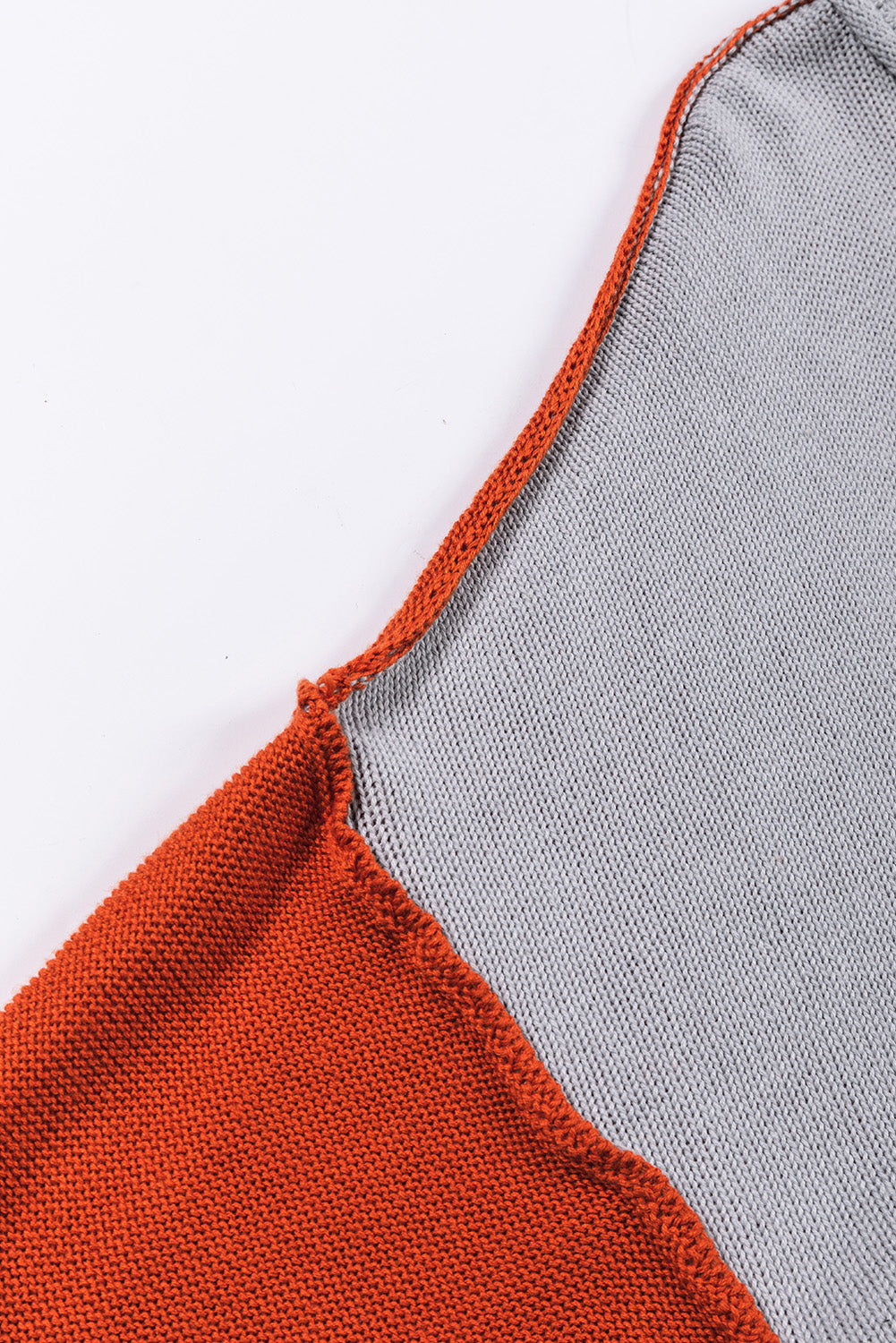 Chic Contrast Cozy Sweater in orange and grey knit fabric with contrast trim detail.