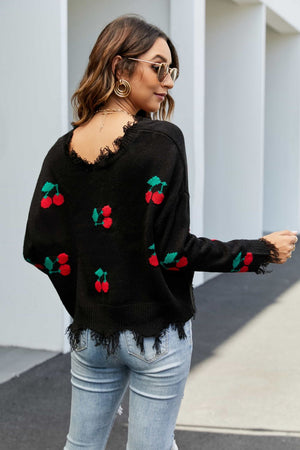 Black acrylic sweater with frayed hem and cherry motif.