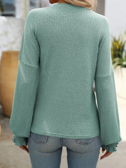 Sage textured ribbed knit blouse with ruffled cuffs and long sleeves.