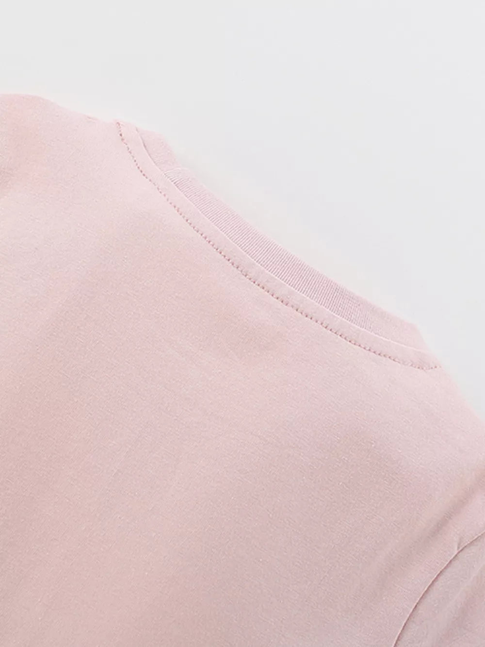 Blush pink cotton blend toddler dress detail showing neckline and stitching.