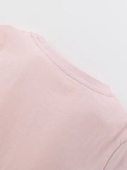 Blush pink cotton blend toddler dress detail showing neckline and stitching.