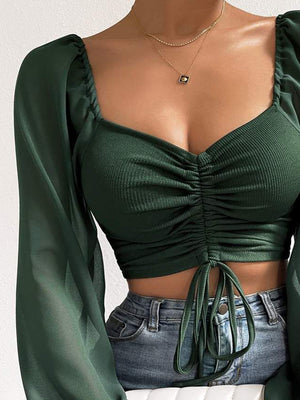 Army green ruched bodice crop top with puff sleeves and drawstring tie.
