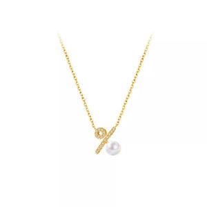 Gold necklace with percentage pendant, cubic zirconia accents, and pearl detail.