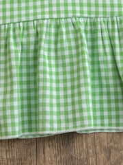 Gingham polo dress in Gum Leaf green with a ruffled hem detail.
