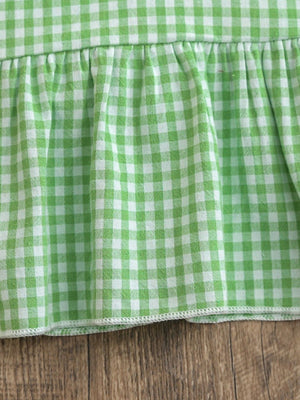 Gingham polo dress in Gum Leaf green with a ruffled hem detail.