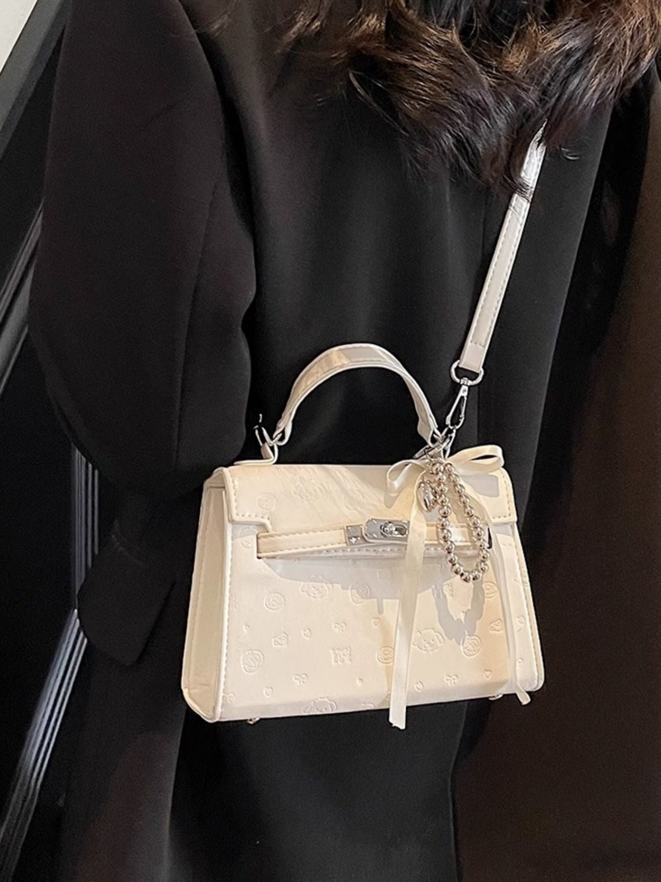 Ivory embossed mini pu leather crossbody bag with ribbon and charm detail