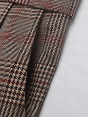 High-waisted taupe plaid trousers with pleat detail and houndstooth pattern.