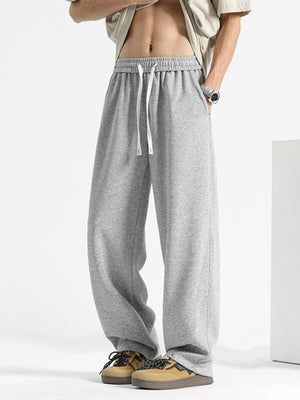 Men's grey sweatpants with drawstring waist and pockets.