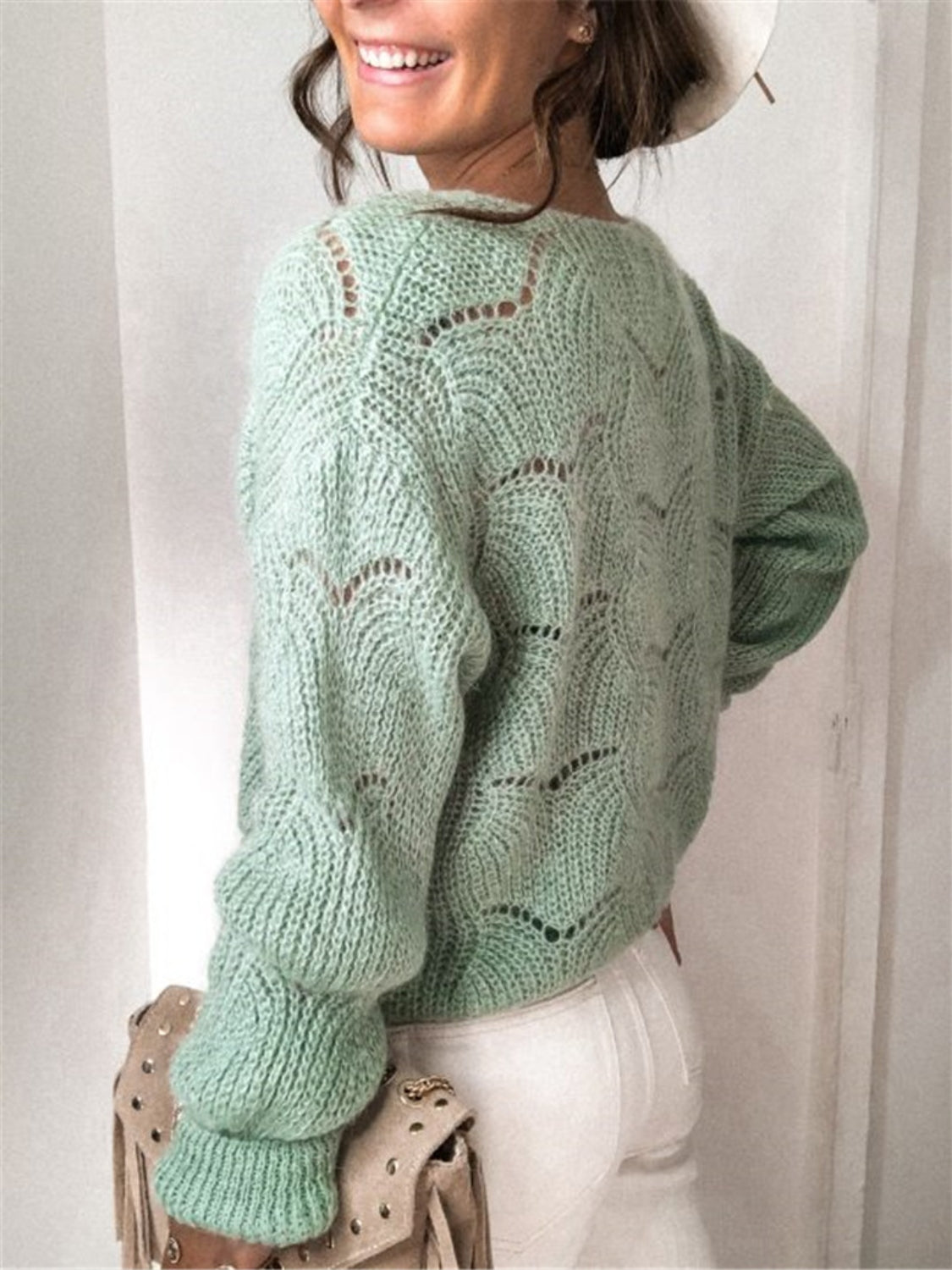 Light green scalloped knit cardigan with openwork pattern and balloon sleeves.