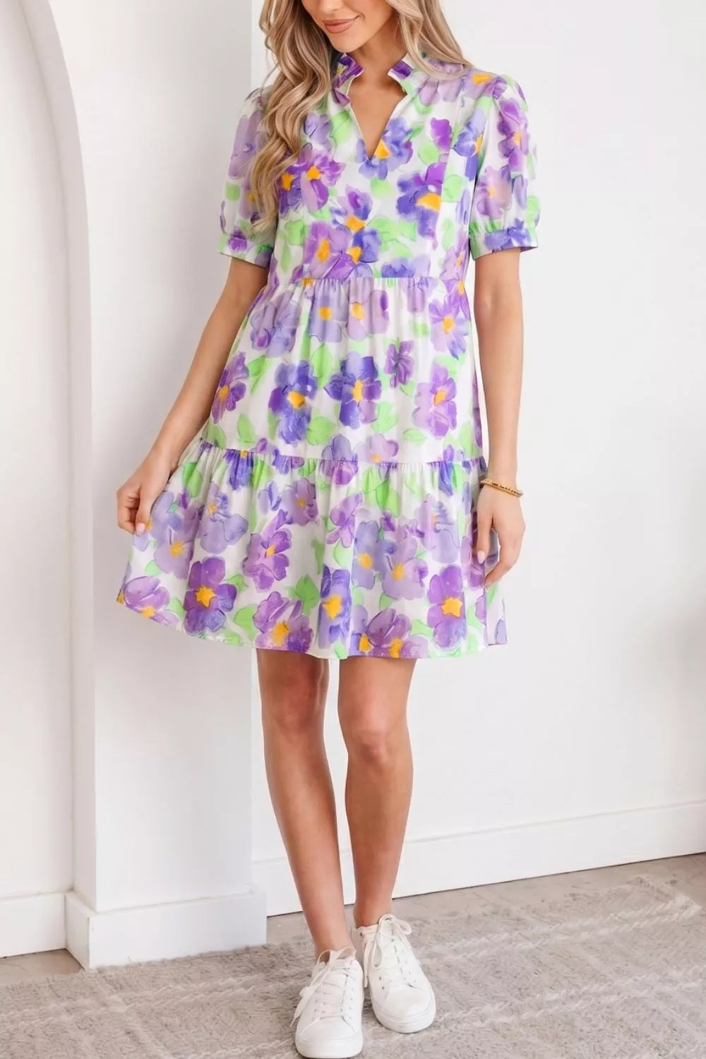 Vibrant floral tiered ruffle mini dress with short sleeves and a V-neck.