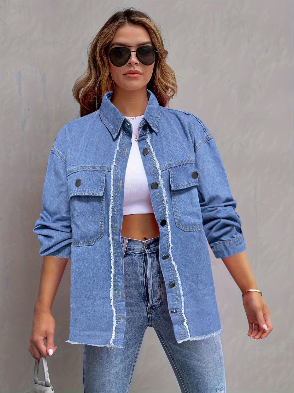 Light wash denim overshirt with frayed edges, button front and chest pockets.