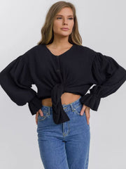 Black textured puff sleeve blouse with ruffled cuffs and tie front