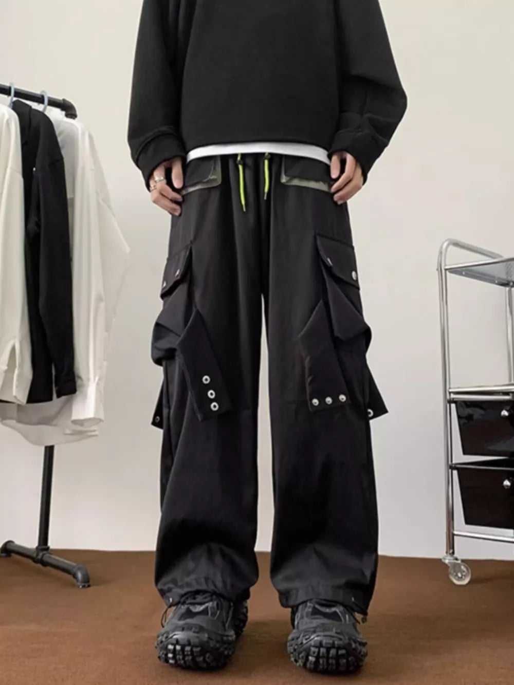 Men's black relaxed-fit cargo pants with multiple pockets and drawstring waist.