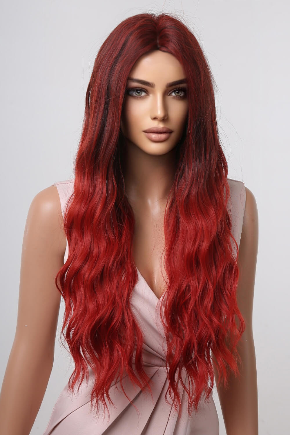 Crimson ombre synthetic wave wig with dark roots and long, wavy red hair.
