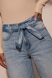 Belted wide-leg denim trousers in medium wash with a tie waist.