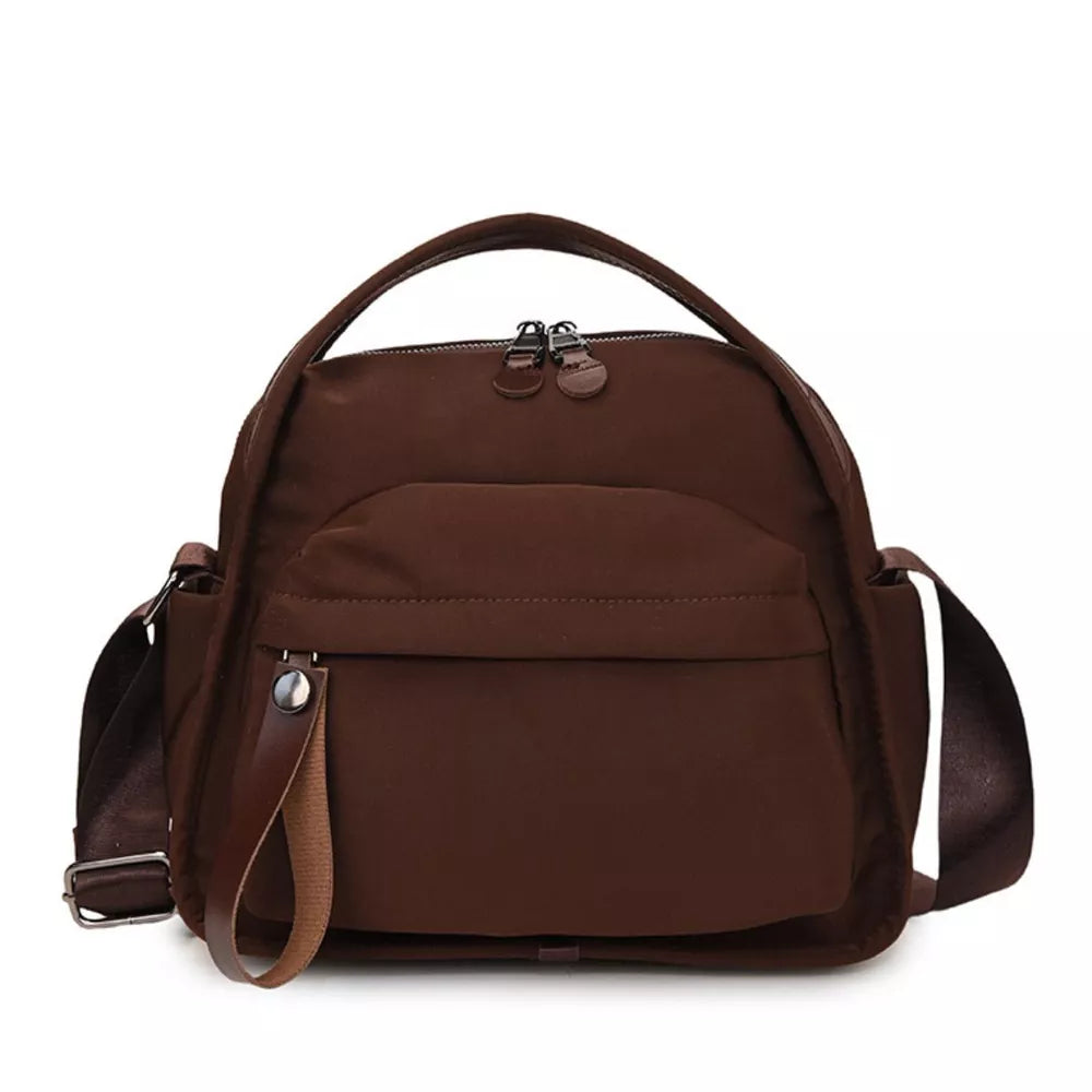 Brown nylon chest bag with adjustable strap and multiple pockets