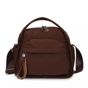 Brown nylon chest bag with adjustable strap and multiple pockets