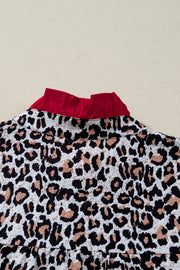 Leopard print polyester shirt with red frilled collar detail.