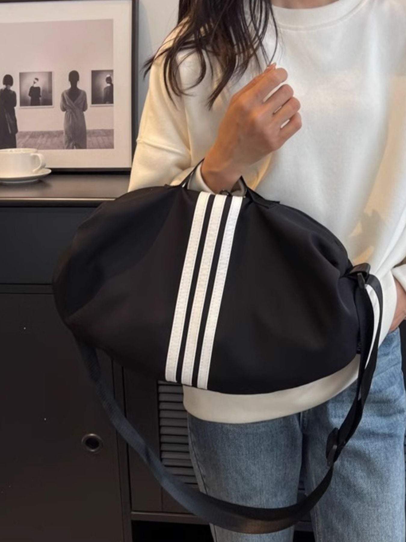 Black Oxford cloth crossbody bag with white stripes and adjustable strap