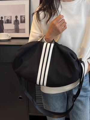 Black Oxford cloth crossbody bag with white stripes and adjustable strap