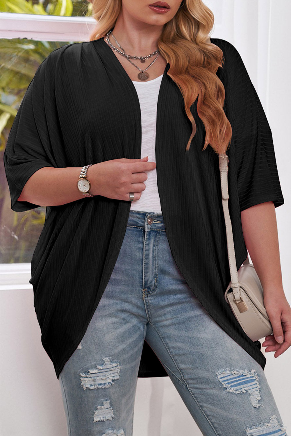 Black ribbed batwing cardigan with drape front and short sleeves.