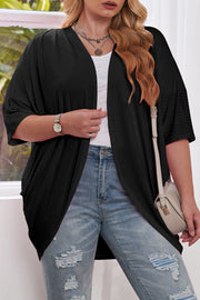 Black ribbed batwing cardigan with drape front and short sleeves.