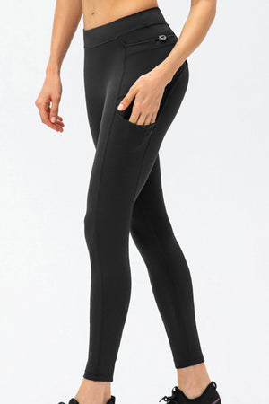 Black athletic leggings with utility pockets and a zippered back pocket.