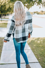Oversized shacket with black and white buffalo check pattern, button-down front, and patch pocket.