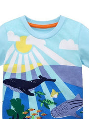 Pastel blue crew neck t-shirt with an underwater scene featuring whales, turtles, and fish.