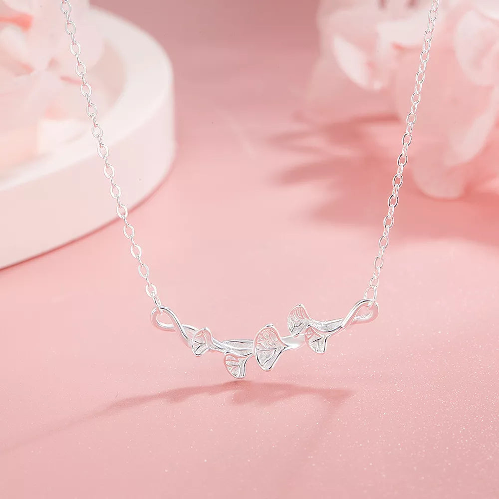 Silver necklace with delicate ginkgo leaf design and fine chain.