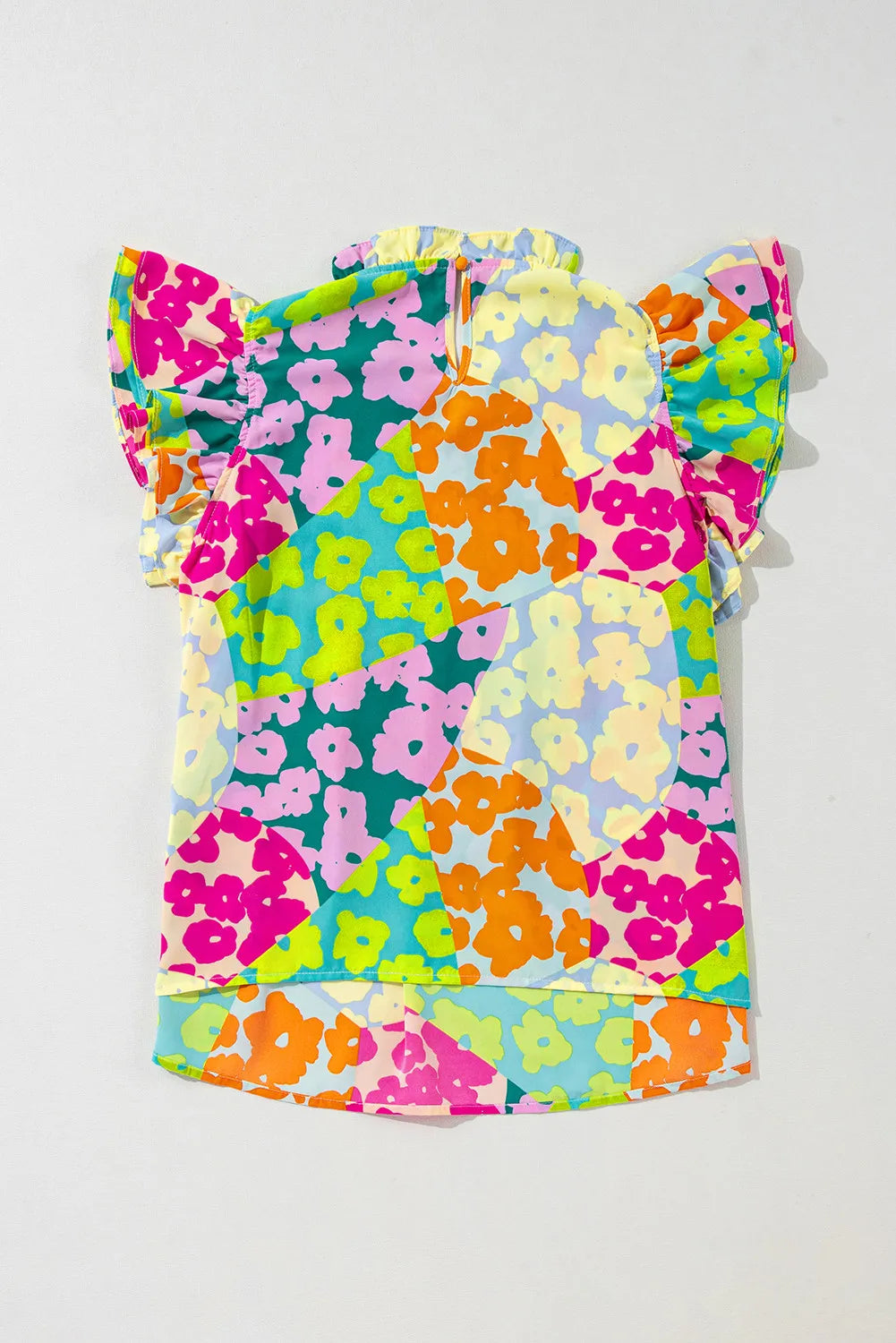 Floral ruffle yoke and flutter sleeve blouse with a colorful patchwork floral print.