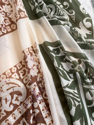 Dual-pattern V-neck cami dress with brown and green prints on a cream background.