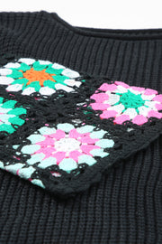 Black acrylic knit pullover with colorful crochet granny square detail on sleeve