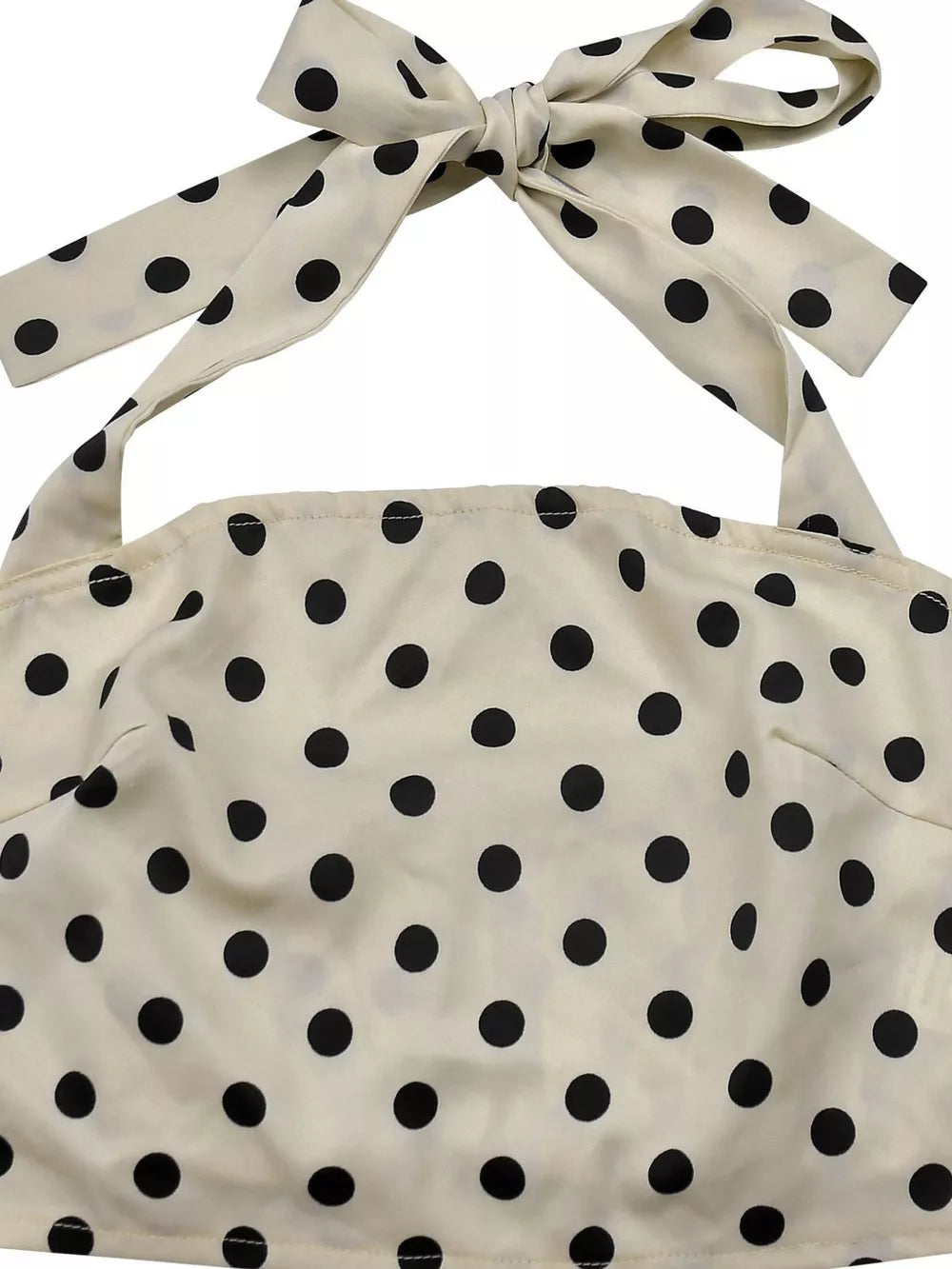 Cream polka dot cami with a tie halter neck and matching bow detail.