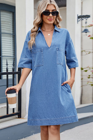 Collared denim mini dress in dark wash with V-neck, short sleeves, and two chest pockets.