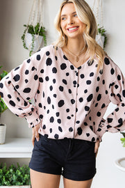 Beige polka dot blouse with balloon sleeves and button front.