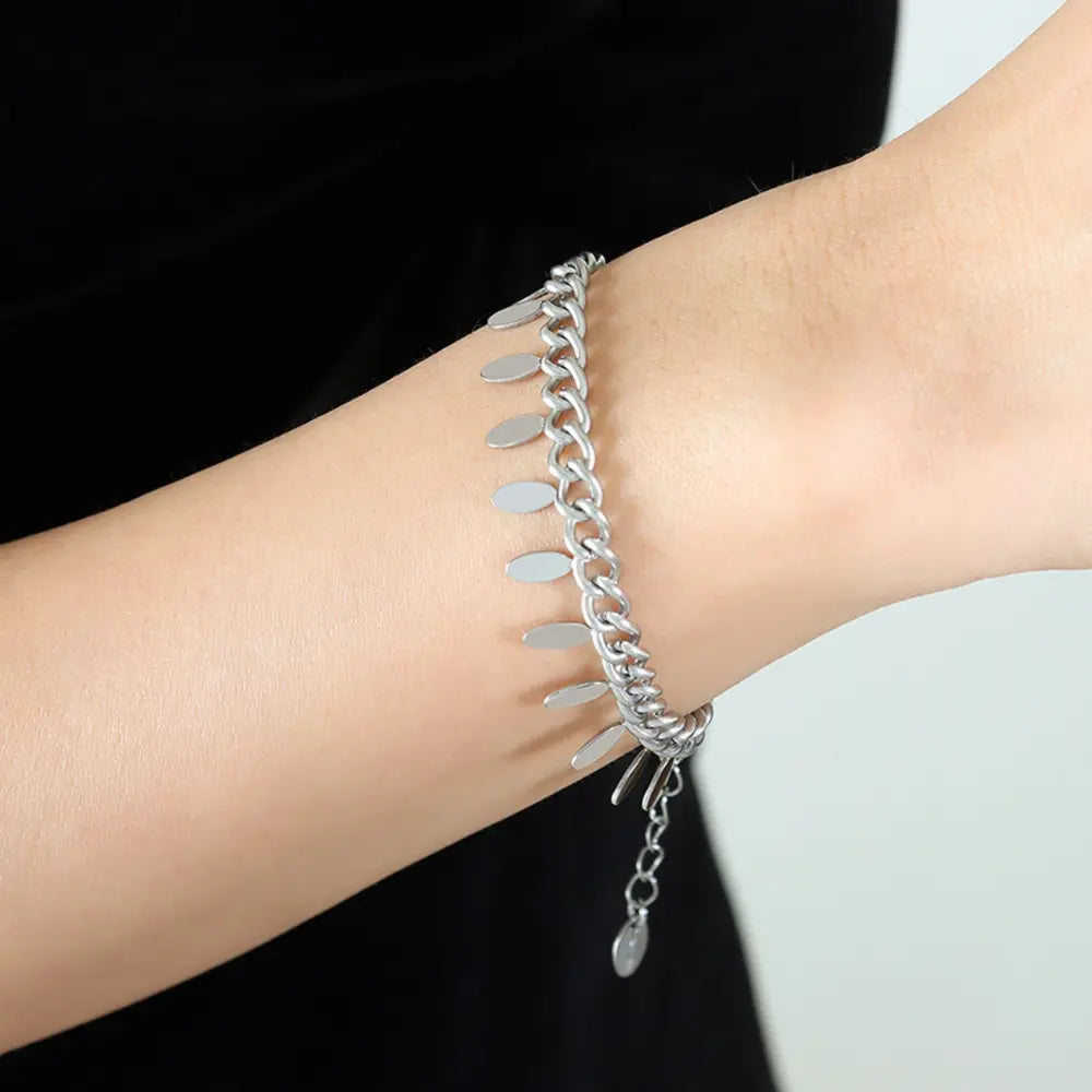 Silver oval link bracelet with dangling leaf charms and adjustable chain