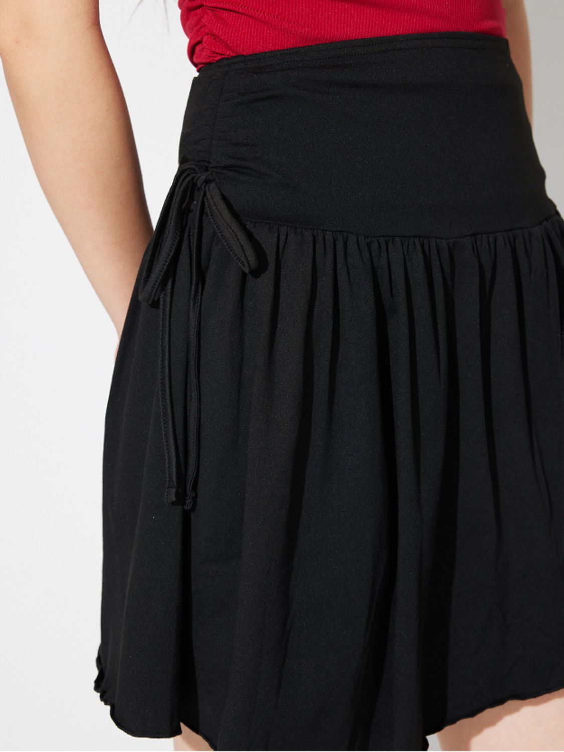 Black draped wrap mini skirt with tie detail and ruched waist