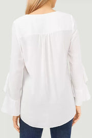 White chiffon blouse with V-neck and flared sleeves, featuring subtle back pleats.