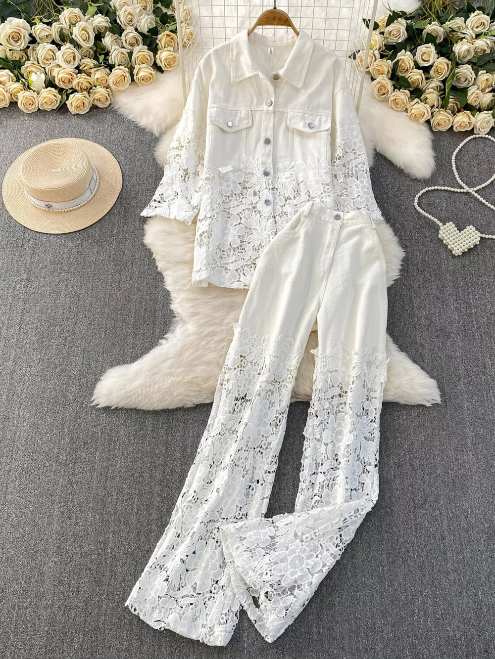 White lace-embellished two-piece set with button-up jacket and wide-leg pants.