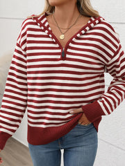 Striped zip-neck hooded knit sweater in burgundy and white acrylic with a relaxed fit.