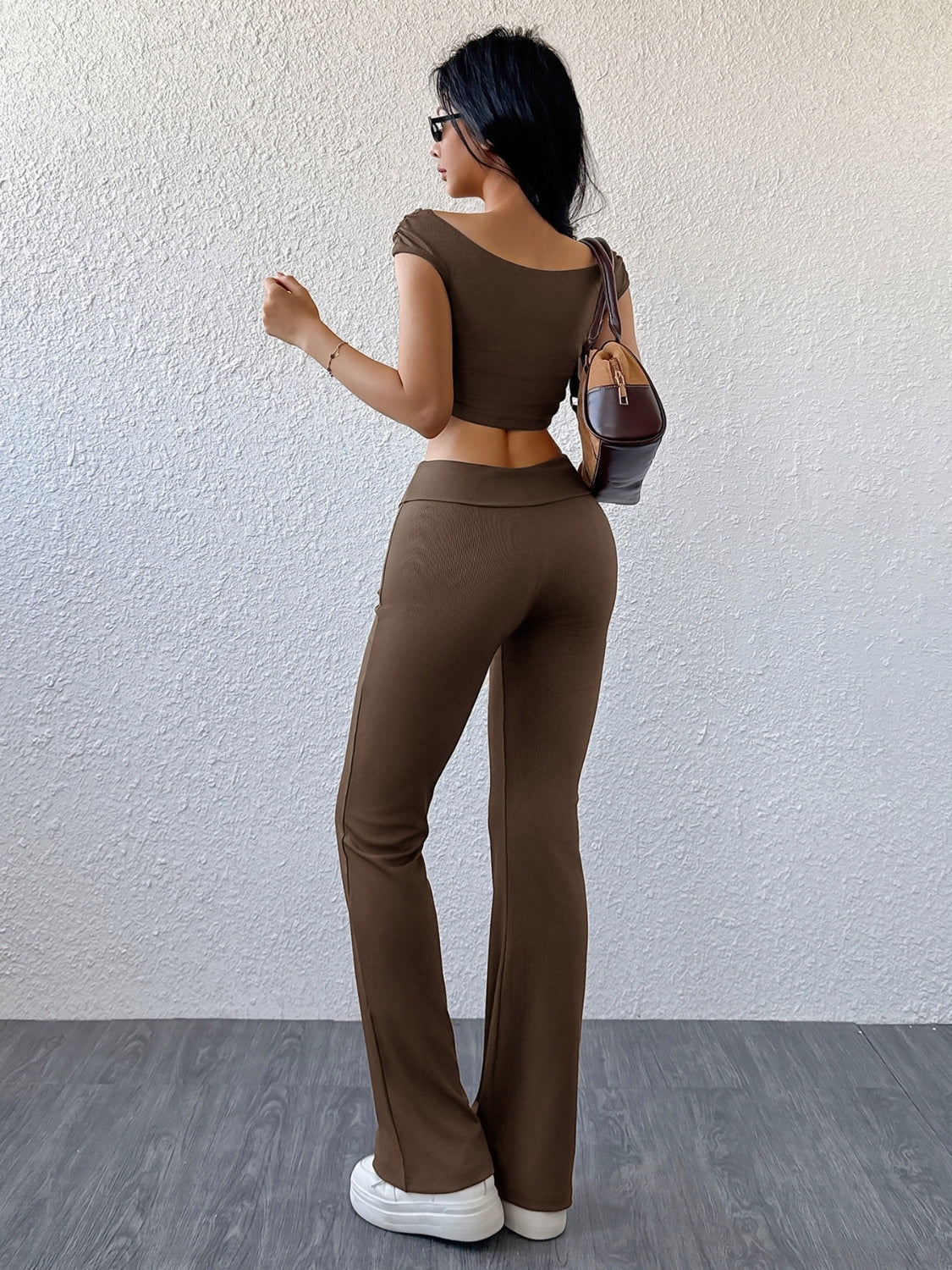 Ribbed off-shoulder crop top and flare pants set in chocolate brown.