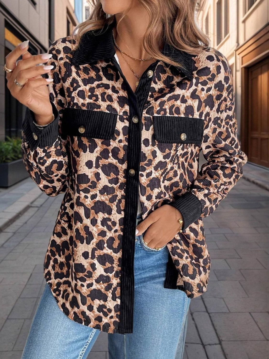 Leopard corduroy utility shirt jacket with black accents and button front.