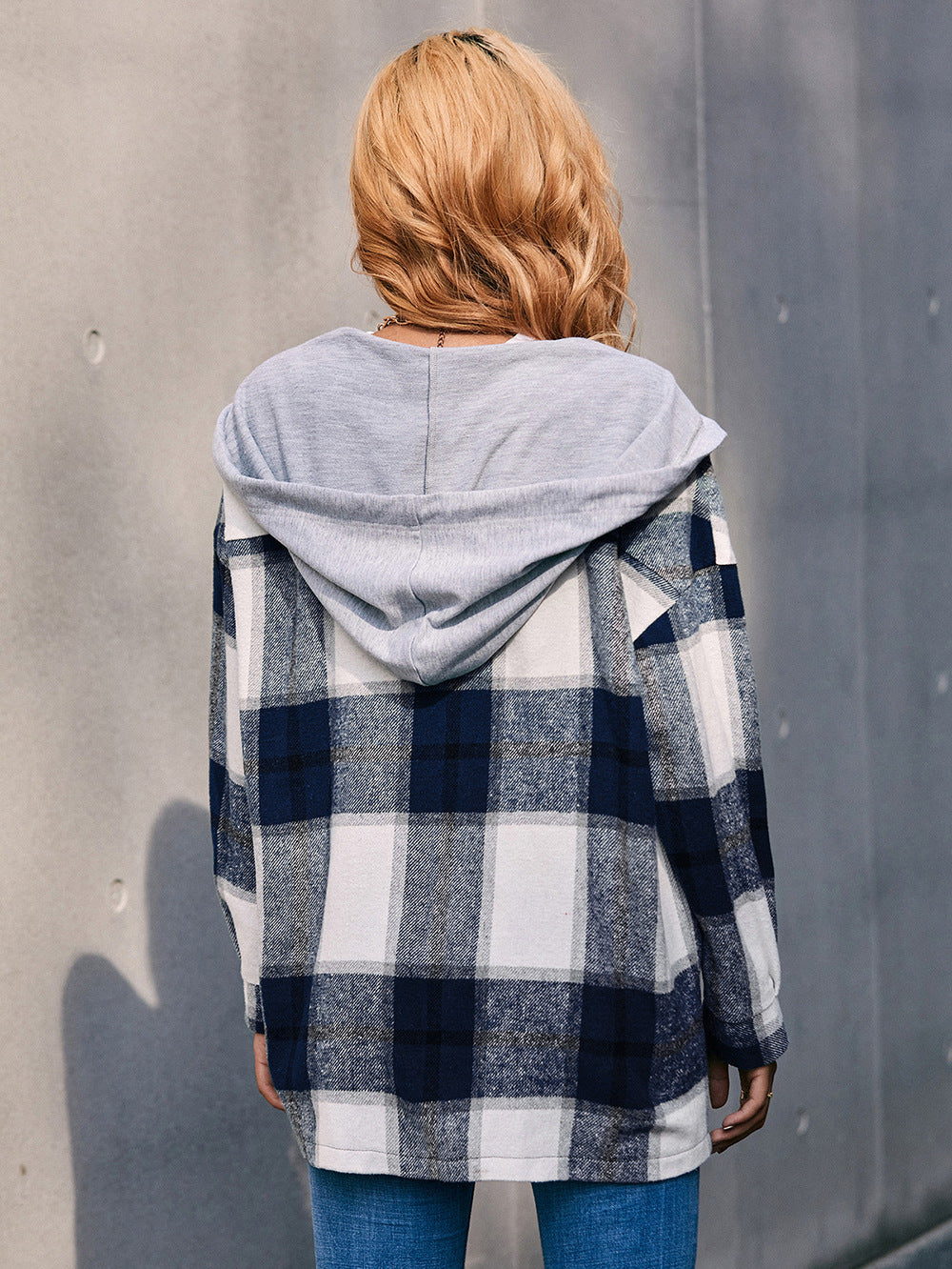 Oversized plaid shacket in dark blue and white with a grey knit hood.